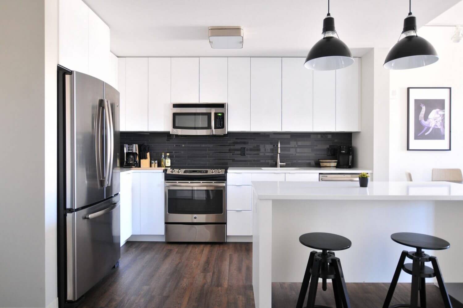 Monochrome Kitchens and Bathrooms inspiration. White kitchen with black appliances and black lighting