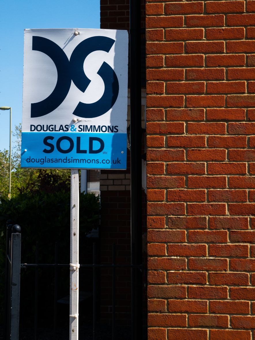 A sold sign outside a house in the UK