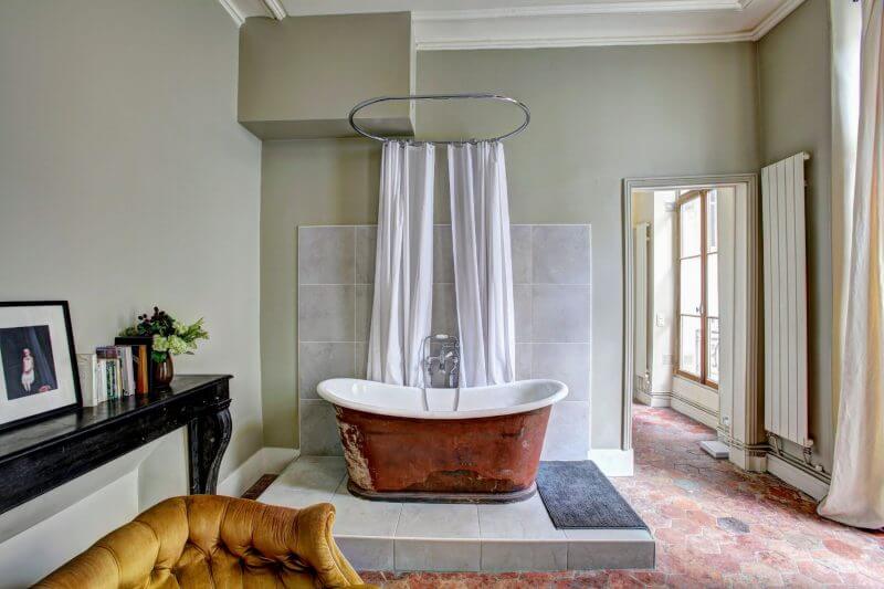Copper bath on stand with curtains