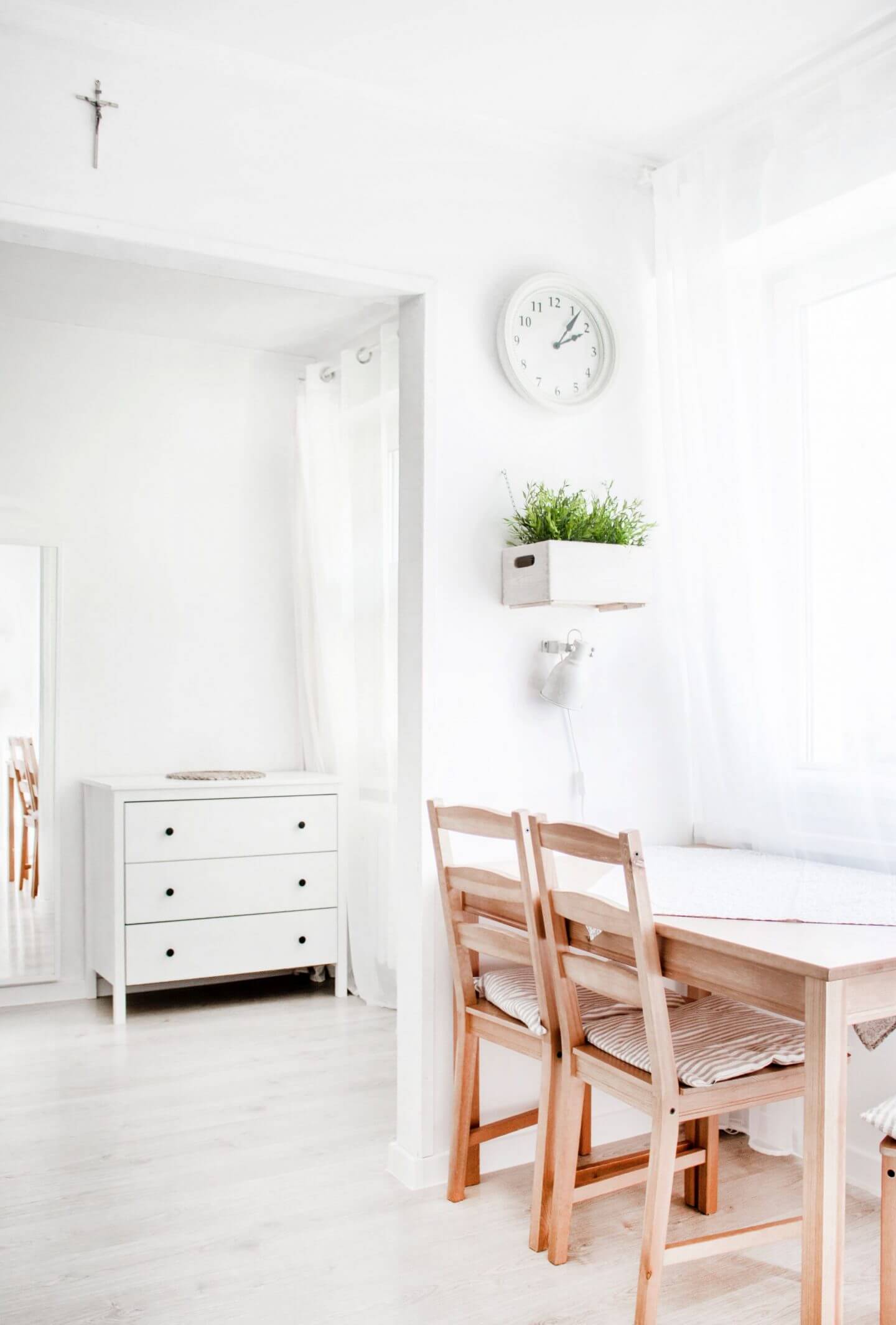 Table and chairs in bright white room