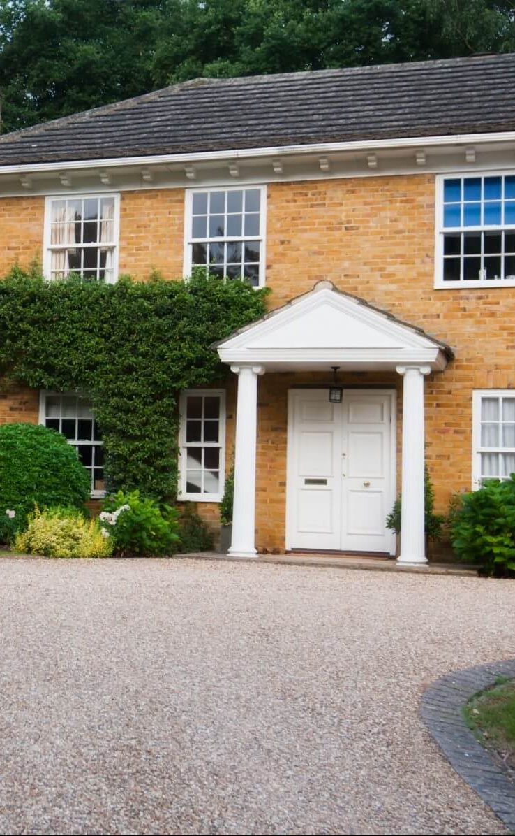 Beautiful British house with white front door and resin driveway