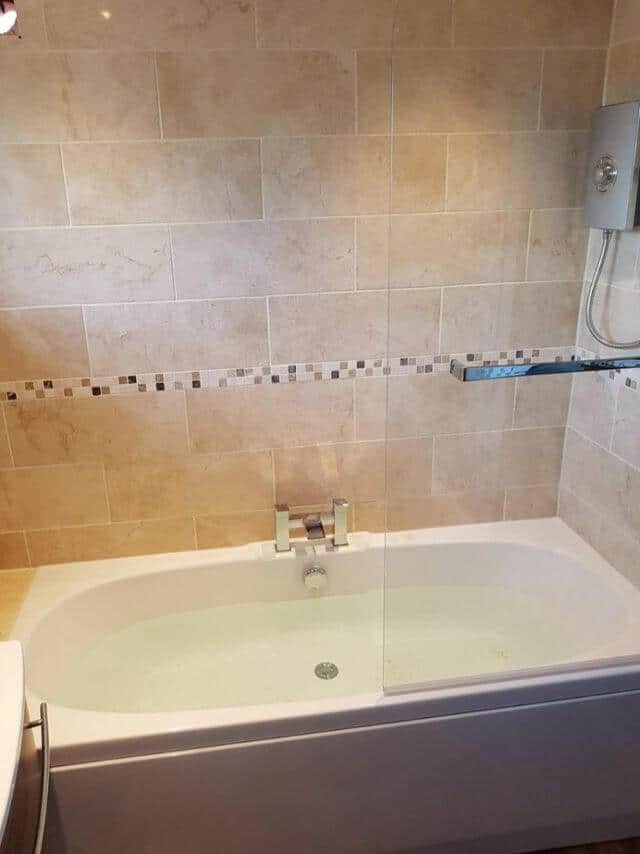 Bath with new tiles and glass door