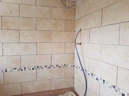 Bathroom during tiling with spacers inbetween tiles