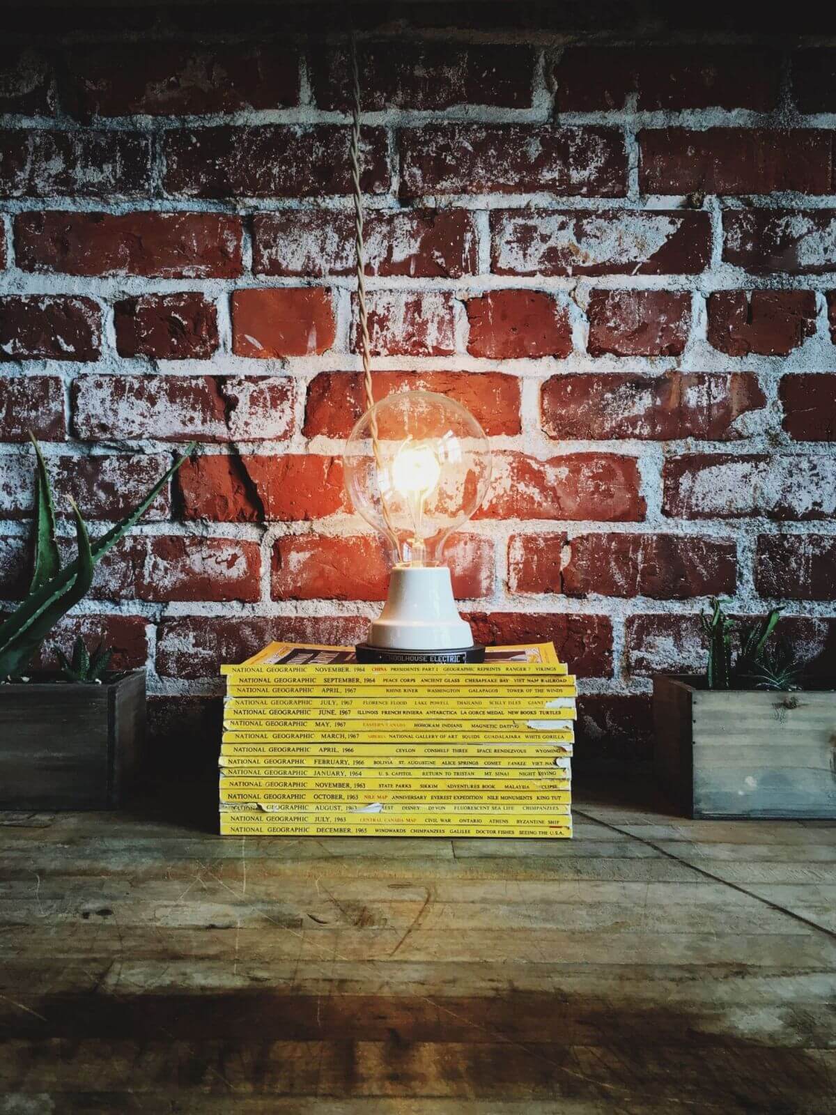 Exposed brick wall with a bare lightbulb