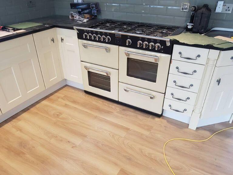 Kitchen with stove cooker and wooden flooring