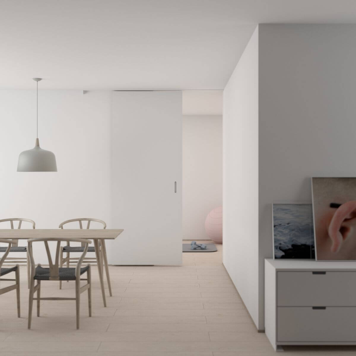 A very plain kitchen space with light floors and walls and a basic dining table