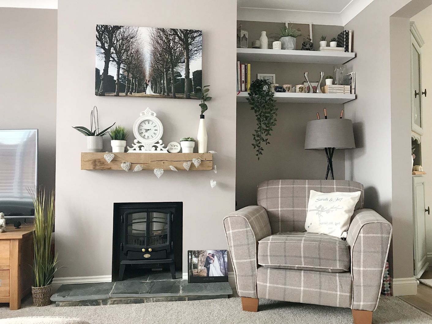 Our living room in Chester with a fire and our wedding photo on the wall.