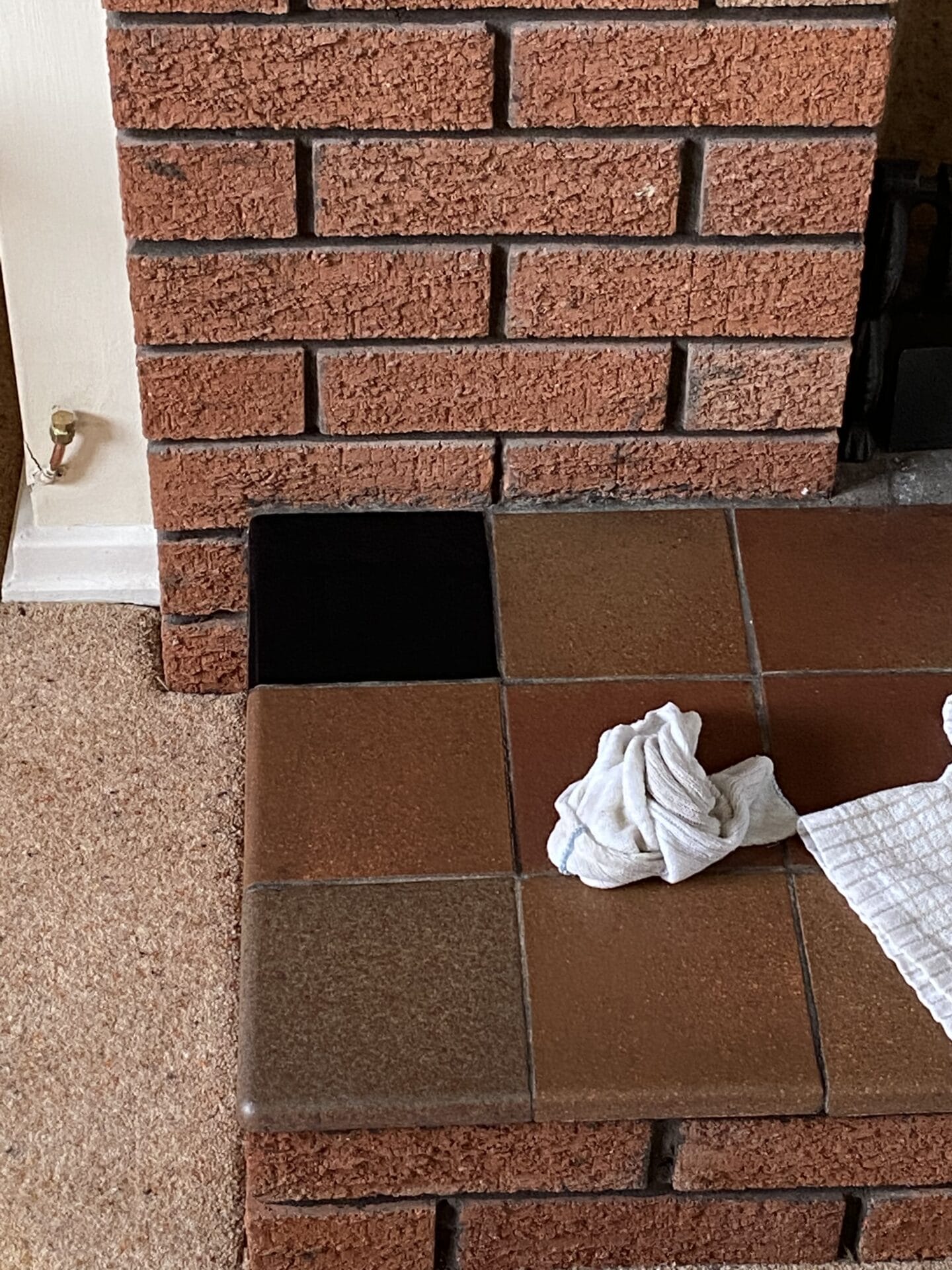 The brown tiles with one painted black