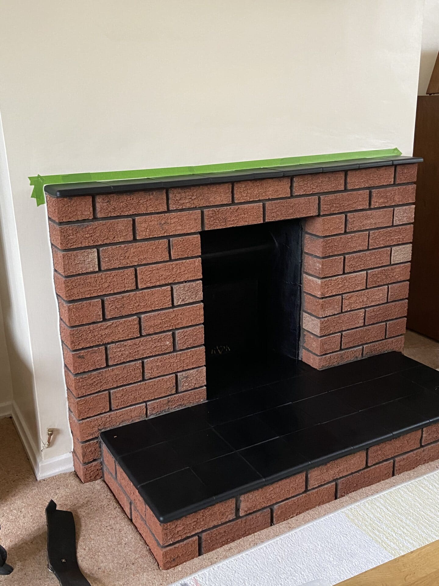 The whole fire painted black with brick surround