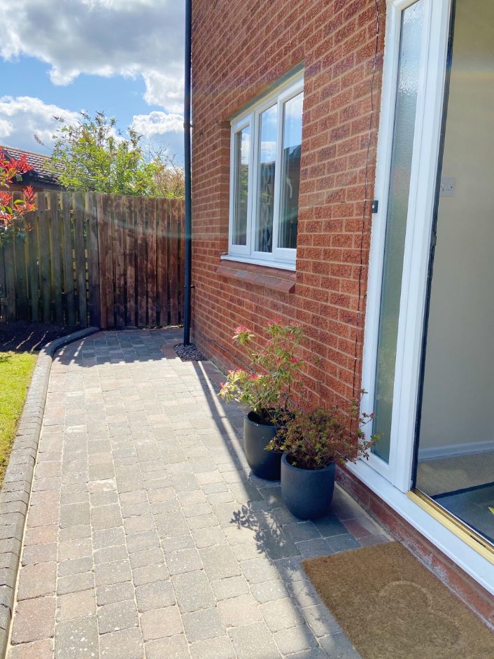 The outside of our house with the washed block paving