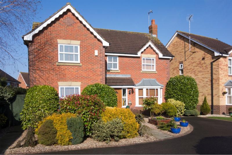 A tidy home in the UK with a large front garden and driveway