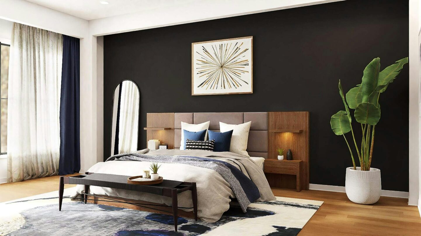Cushions aranged neatly on a bed against a black wall