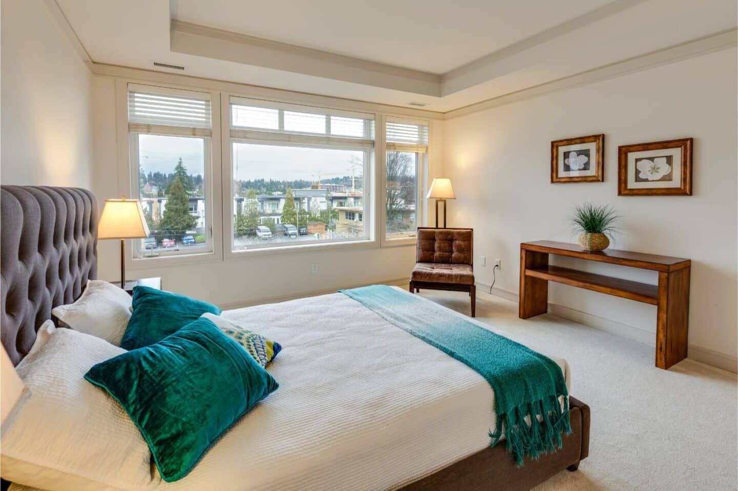 A neutral bedroom with jewel toned accessories