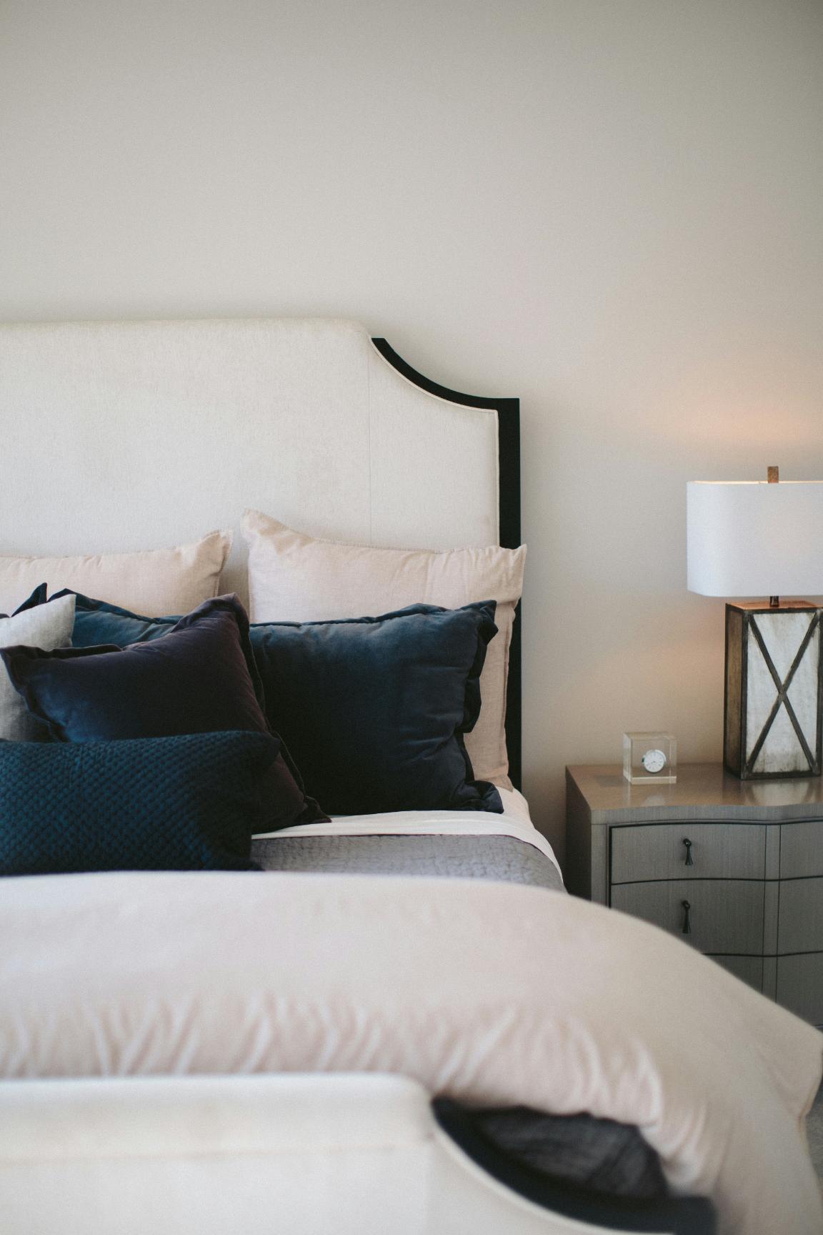 A neutral bedroom with white walls and bedding
