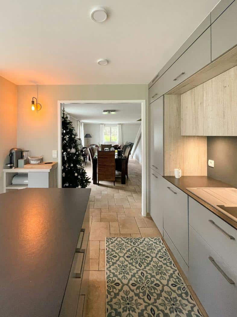 A large galley kitchen with a Christmas tree in it