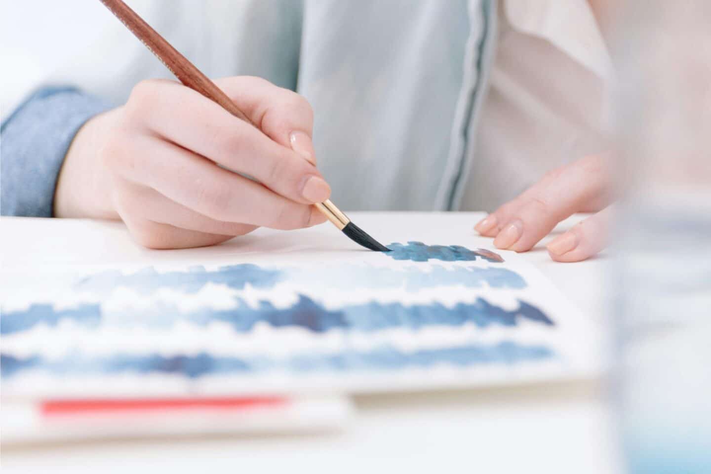 A person using watercolours on card