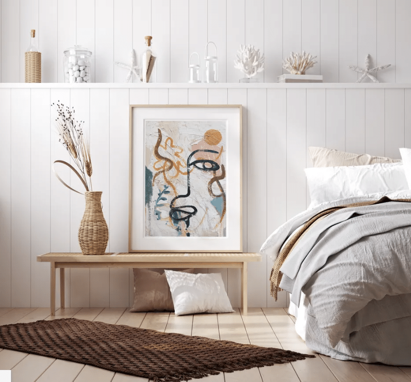 Artwork of a colourful face next to the bed