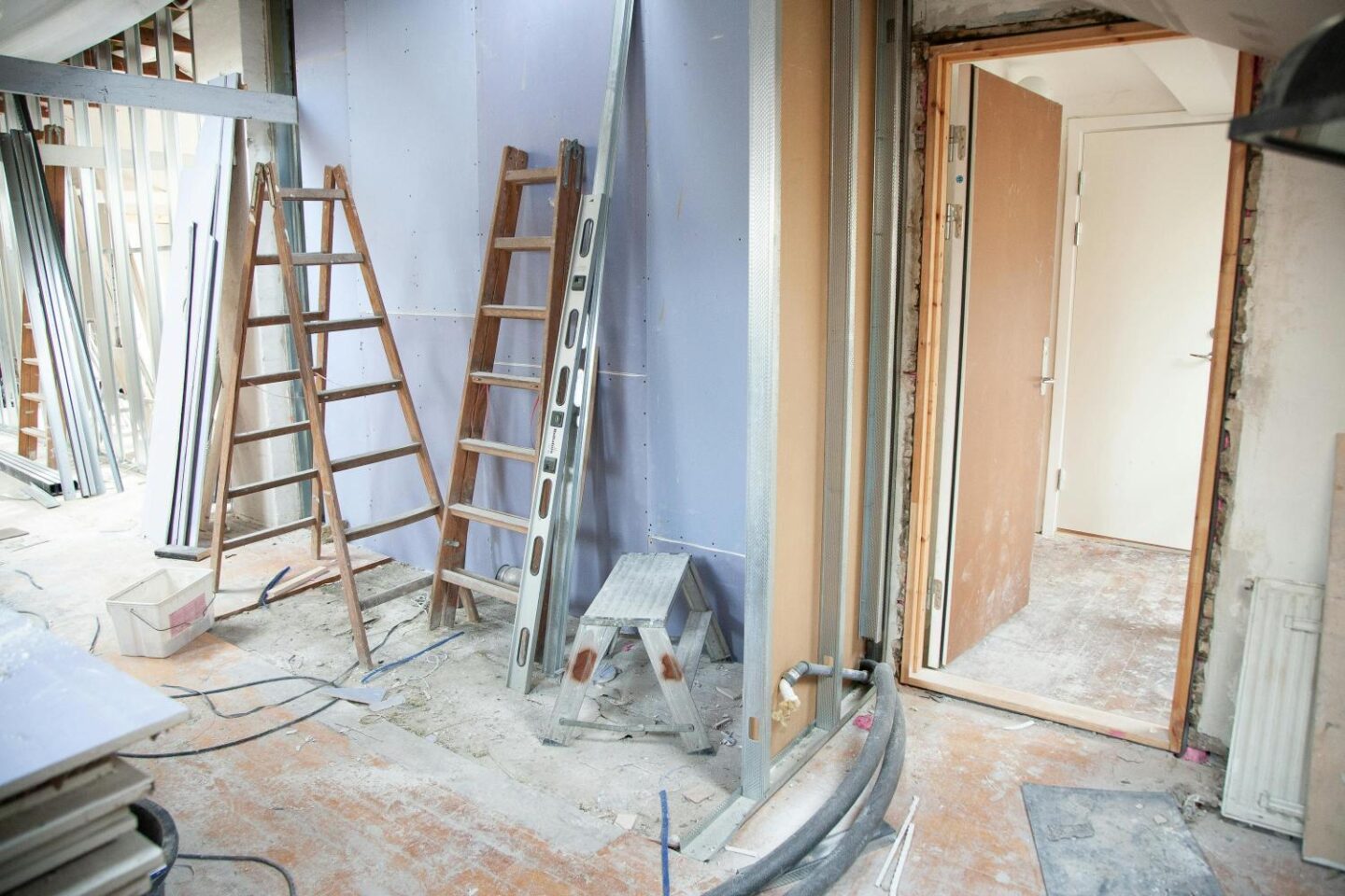 A house mid renovation with step ladders against the wall