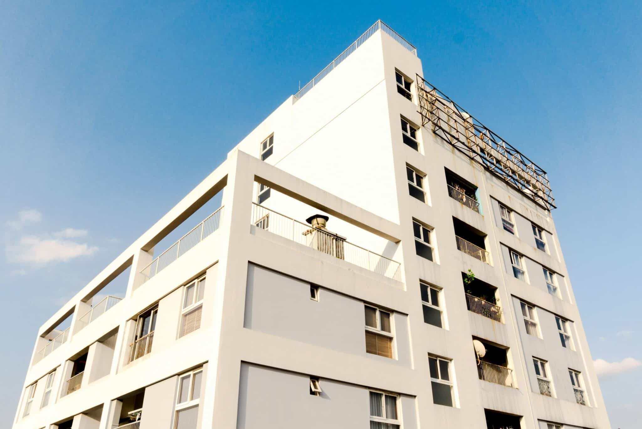A block of strata apartments against blue sky