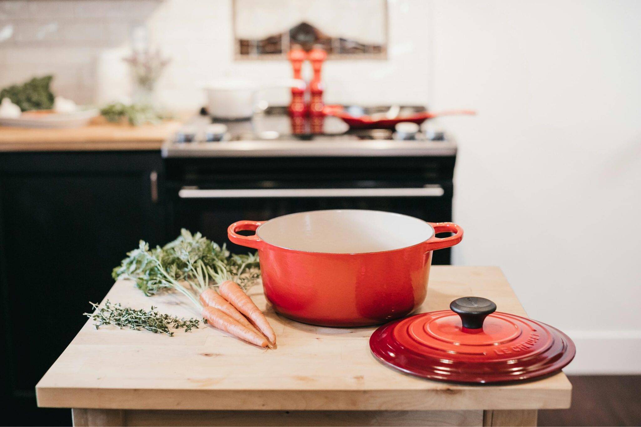 An orange Le Creuset dish on a chopping board