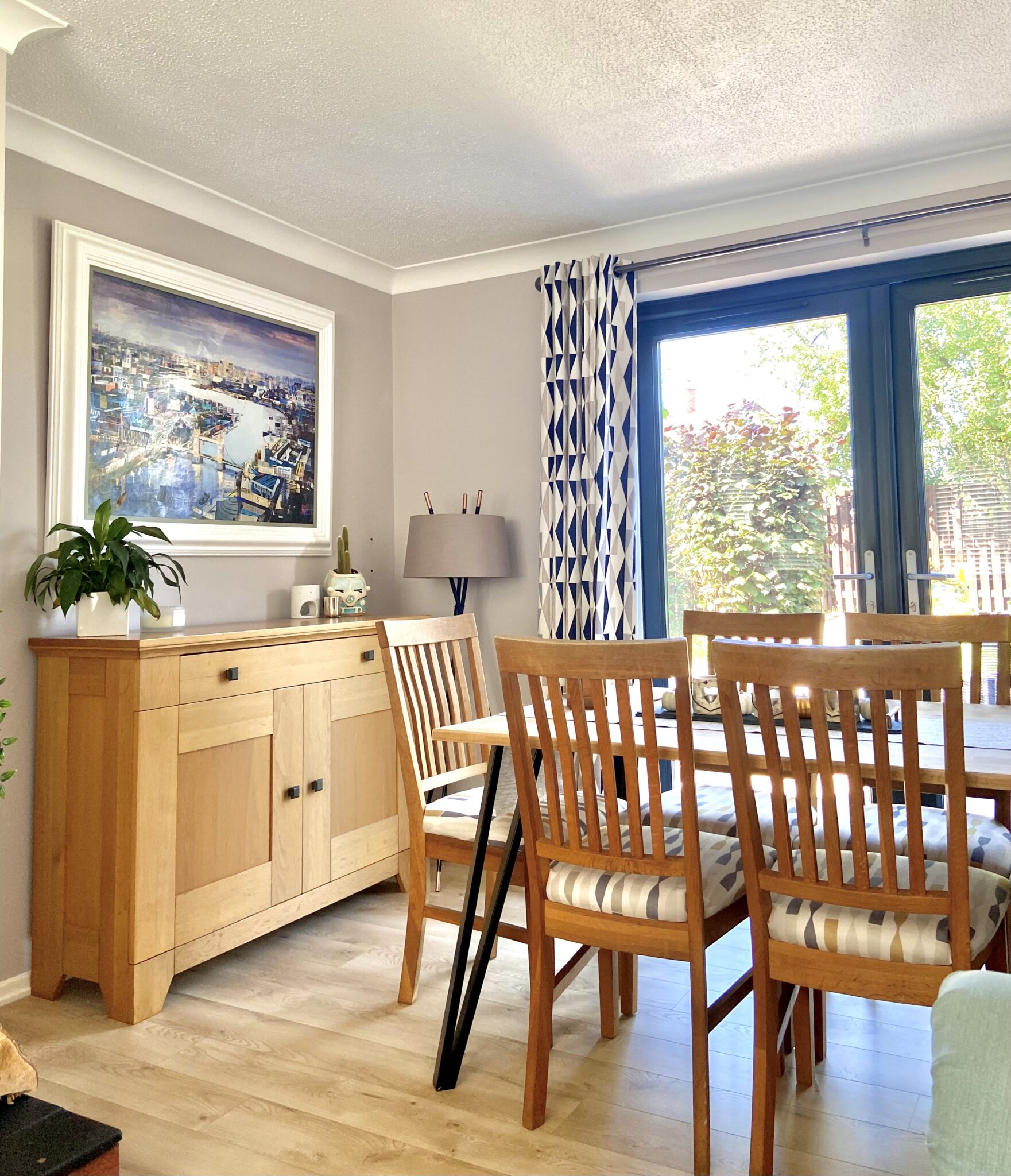 Our dining room with a Tom Butler original print on the wall
