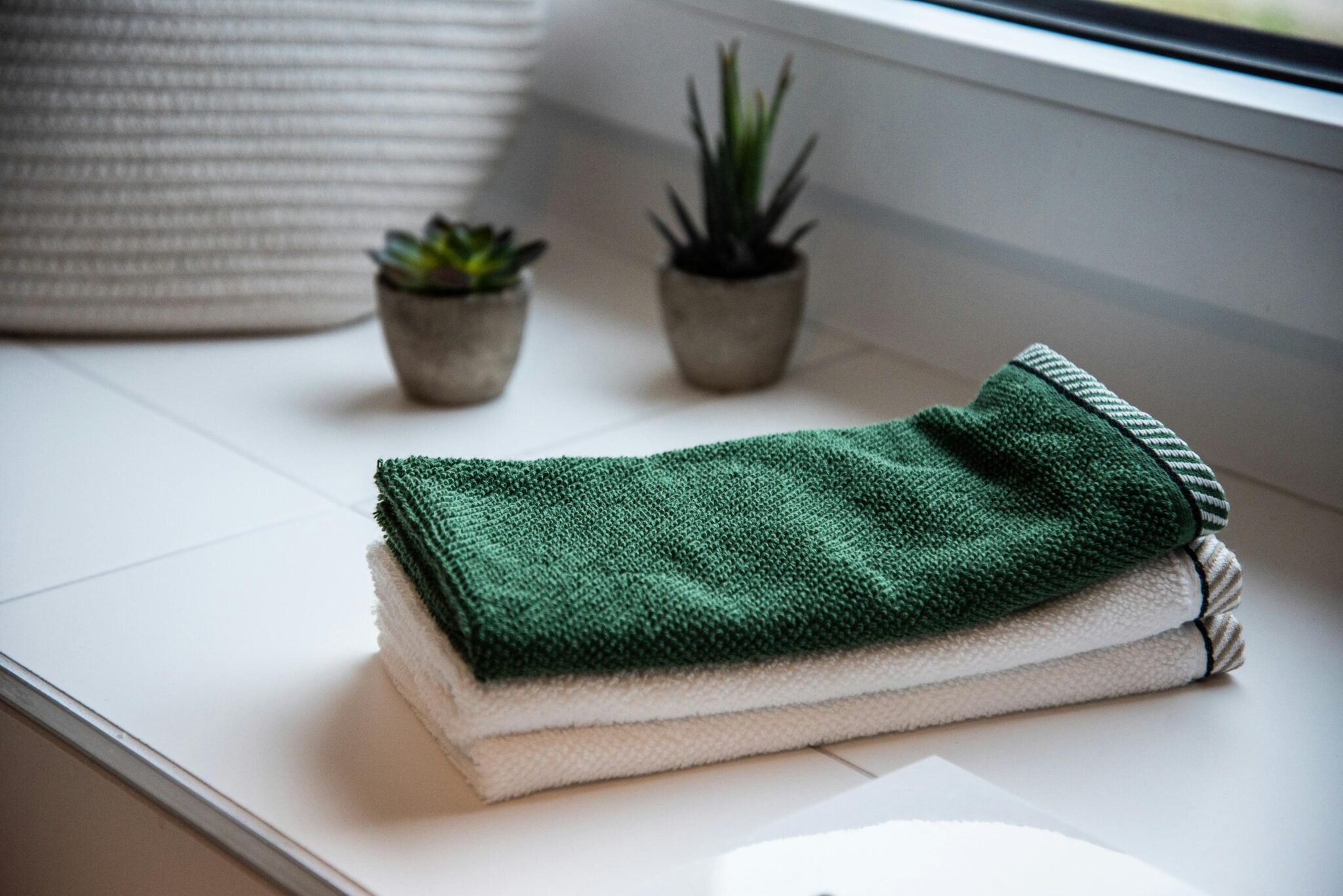 Towels folded and stacked in a bathroom