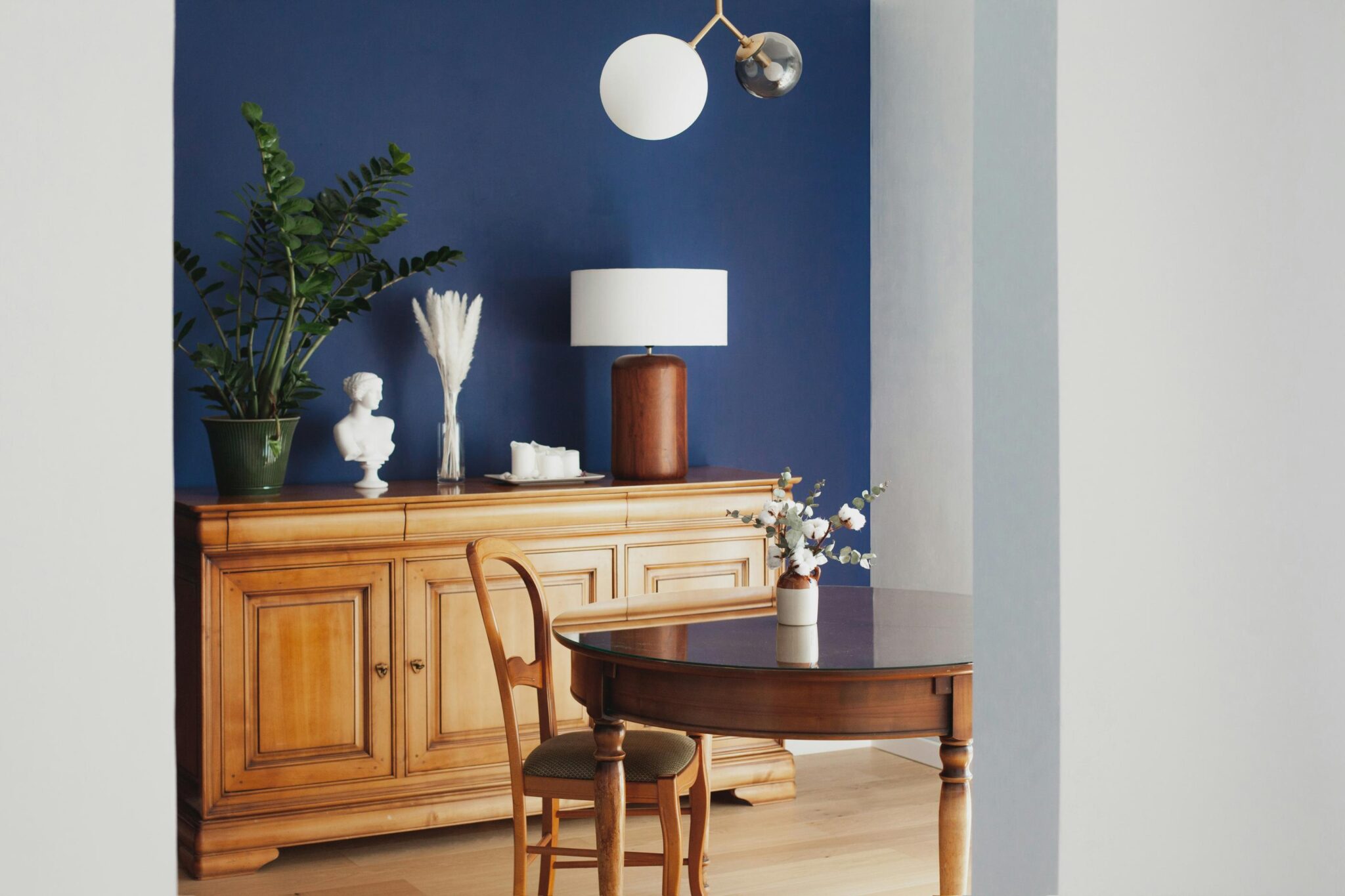 A blue feature wall in a modern home dining room