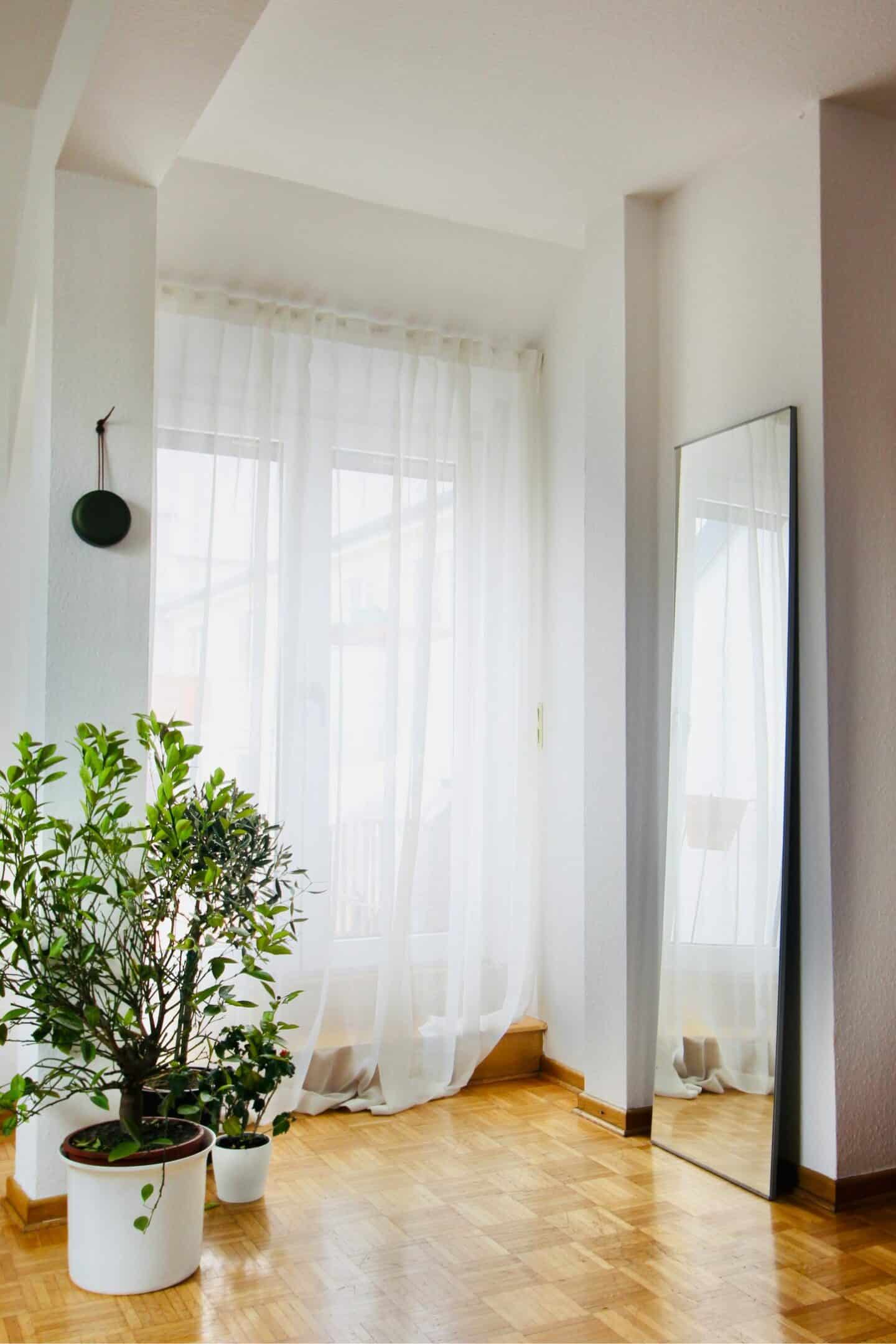 Sheer curtains across a window letting lots of natural light in
