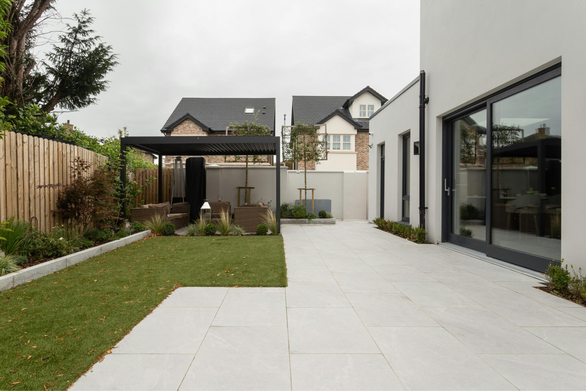 A stunning home extension with bifold doors and white rendered walls